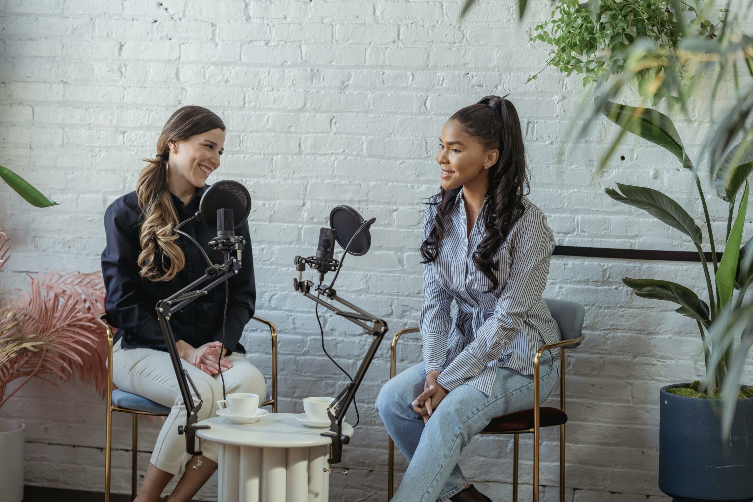 Two women are recording a podcast session in a studio, focused on the topic of advertising revenue for associations.