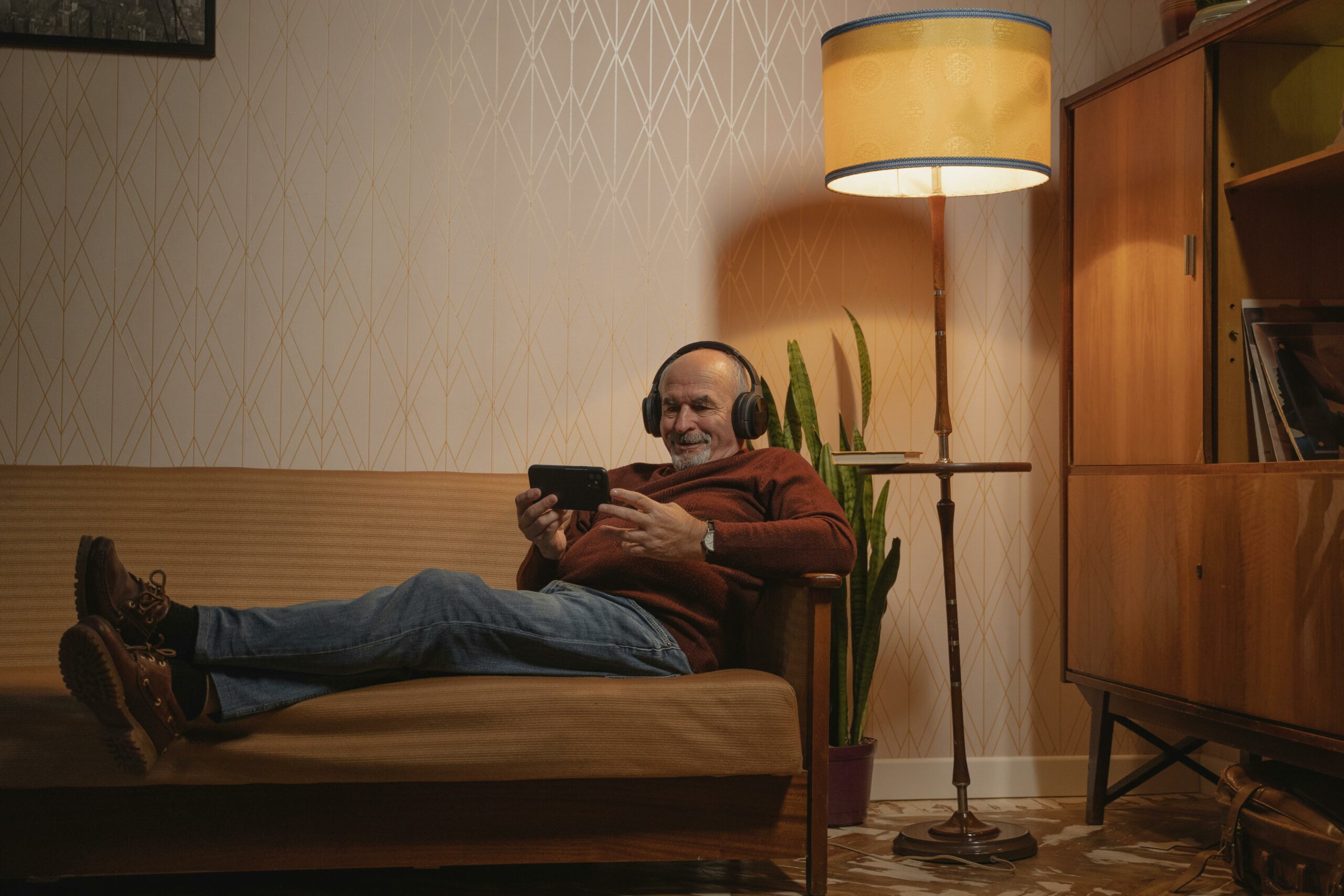 a man is watching a video and smiling as an association used a video for their membership retention strategy