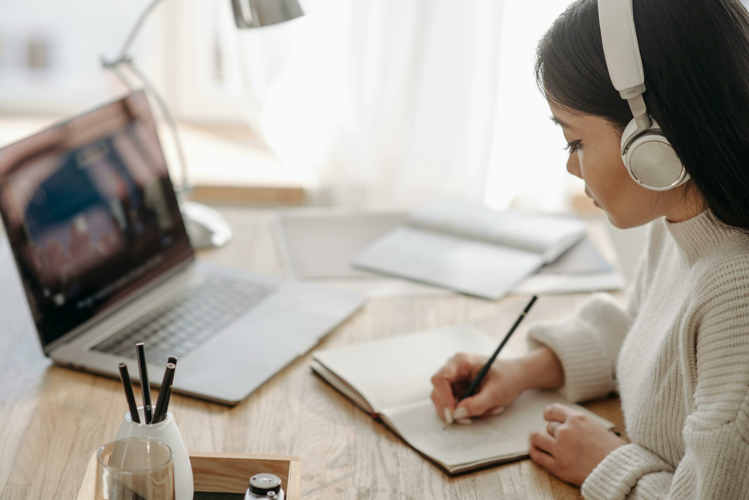 A woman is watching a webinar from a Learning Management System of her association