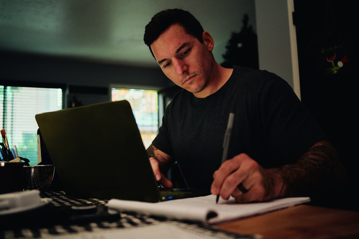 Nick writing at his desk