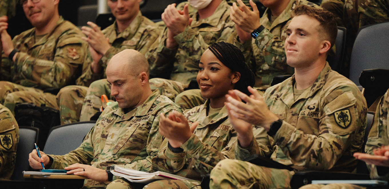 Brittany attends a lecture with fellow service members