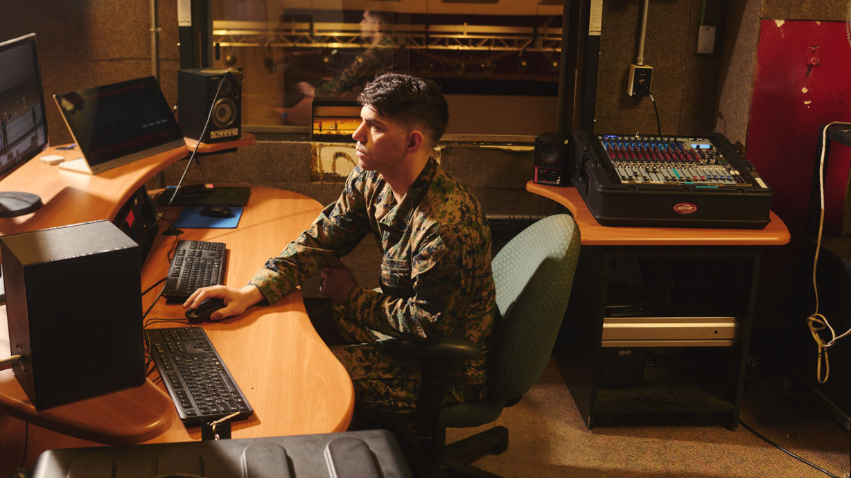 AV tech works in the broadcast booth