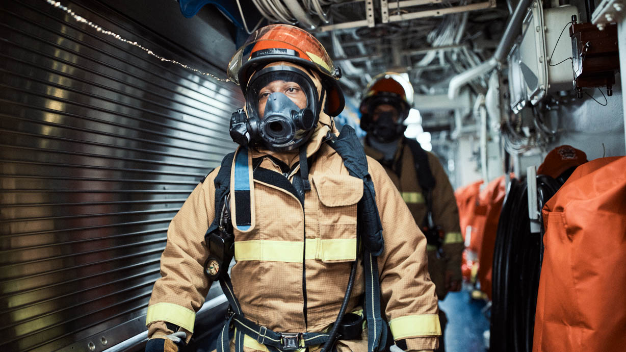 Military firefighter wears protective equipment to fight fires