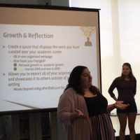 Woman lecturing in front of projection of slide "growth and reflection"