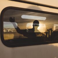 Person in silhouette riding a train