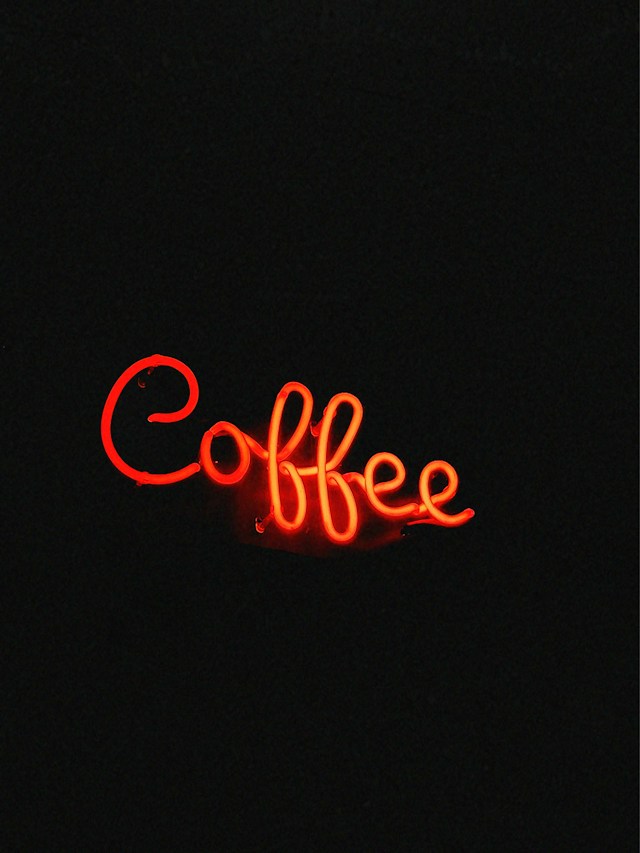 Red neon sign that says coffee