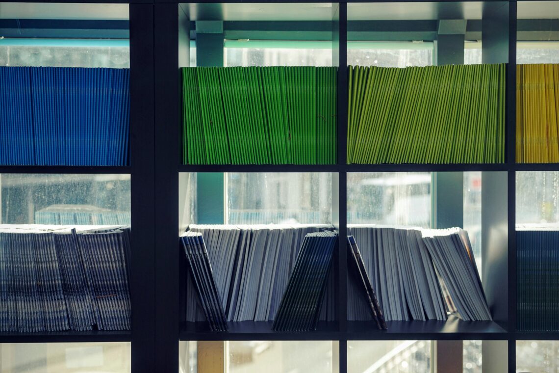 Different colored file folders arranged neatly on shelves