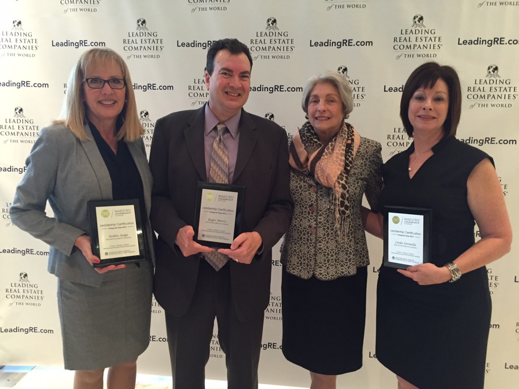 MSC Managers, Debbie Judge, Roger Morris, and Linda Formella pose for a shot with Michael Saunders after receiving their Maestro Leadership Certification from LeadingRE.