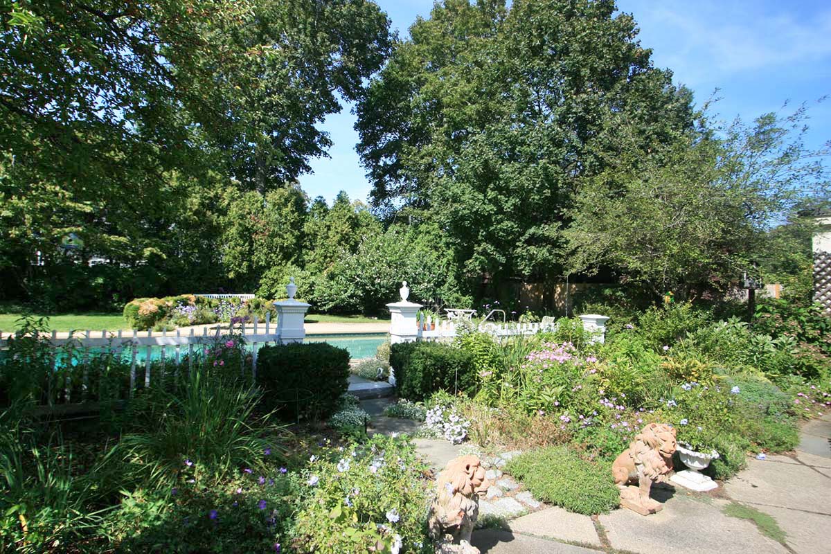 Mature trees and plantings surround Beverly Farms Compound courtyard