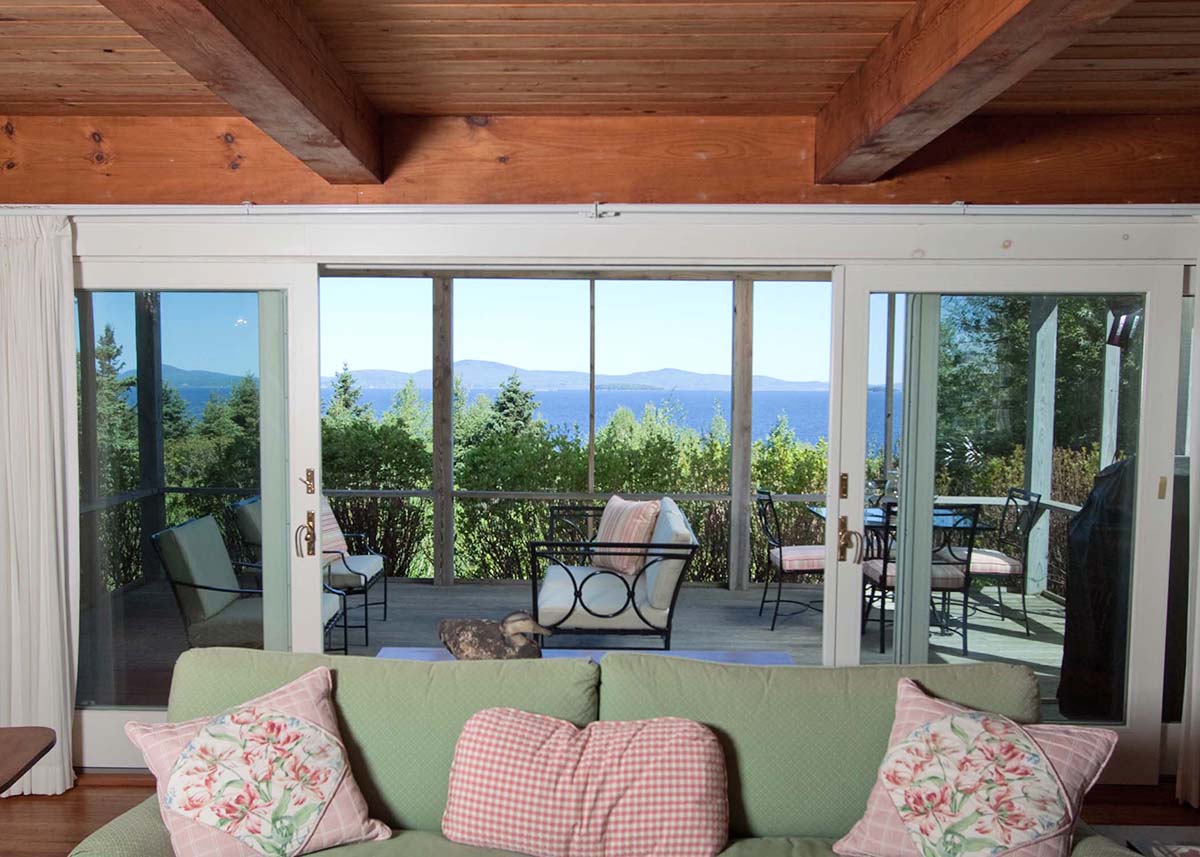 Living room and porch with views. Crabtree Point Cottage, North Haven, ME ME1118_9