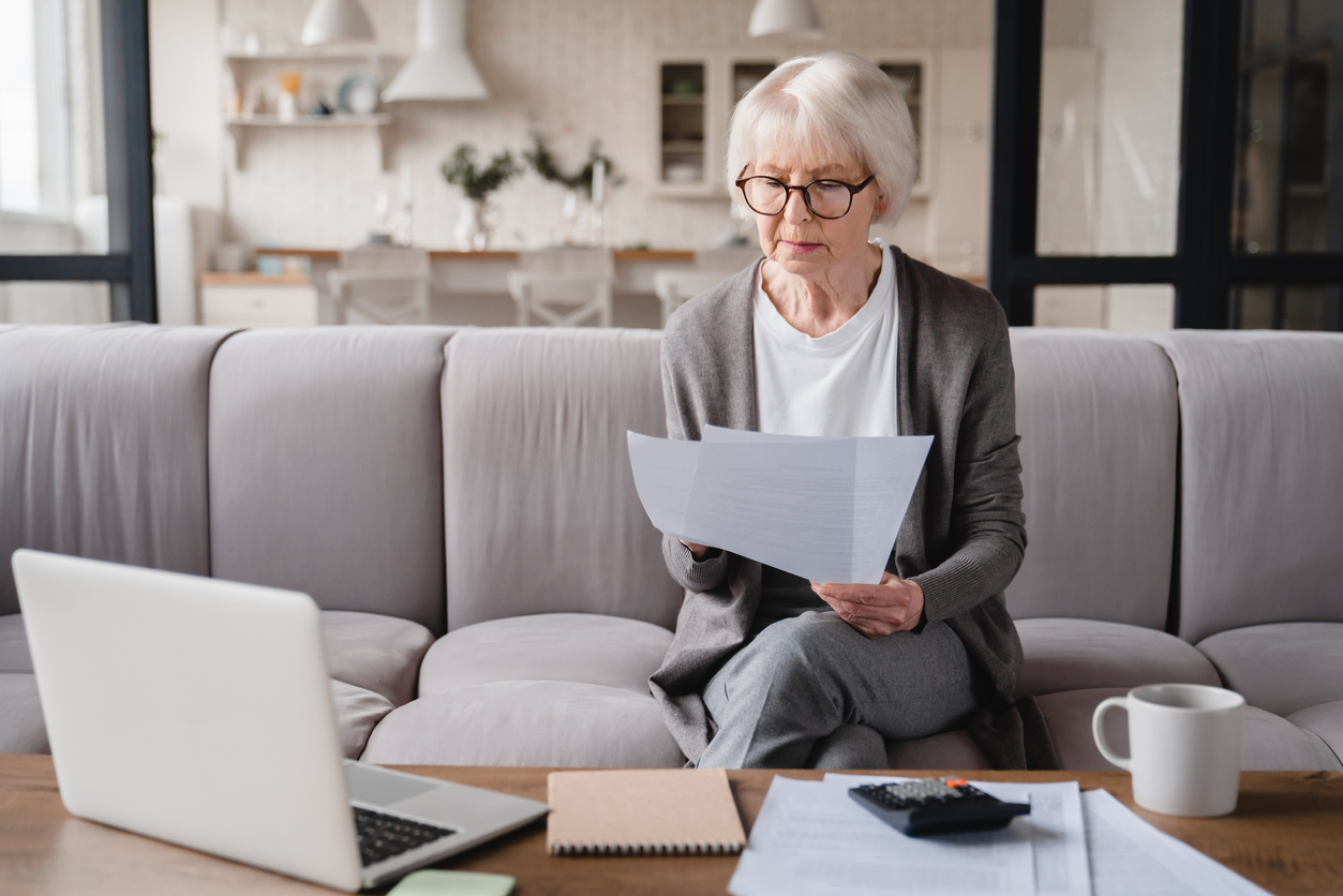 A senior first-time home buyer checks her documents for the mortgage interest tax deduction
