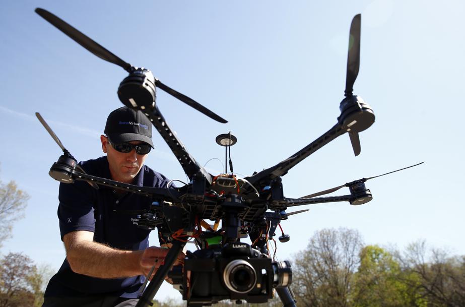 Matthew Murphy, president of Boston Virtual Imaging, prepares his drone for flight (image from bostonglobe.com | Jessica Rinaldi / Globe Staff)