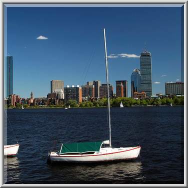 Skyline of Boston with sailboats in water in the foreground