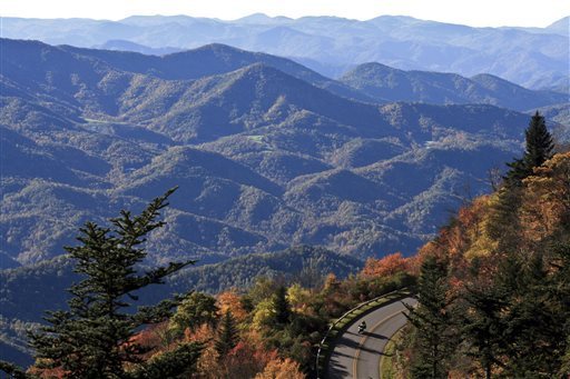 This Sept. 2007 file photo released by the Explore Asheville shows a motorcyclist on a scenic fall drive along the Blue Ridge Parkway near Asheville, N.C. This gem of a city tucked in the Blue Ridge foothills of western North Carolina attracts artists, musicians, foodies, outdoor enthusiasts and a fair share of modern-day hippies, all lured by the beautiful setting and open-minded vibe. EXPLORE ASHEVILLE, VALERIE L. JENKINS -- AP Photo