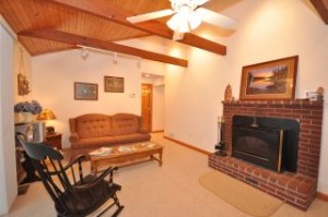 11 Fuhr Drive Living Room has sliders to lakeside deck, fireplace, and vaulted ceiling.