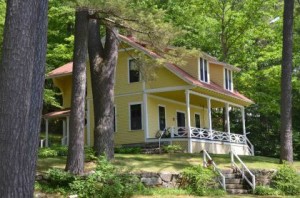 This Winnipesaukee classic cottage was designed with 5 upstairs bedrooms, including maids's quarters. A vaulted Living Room with fireplace below opens to a West-facing porch.