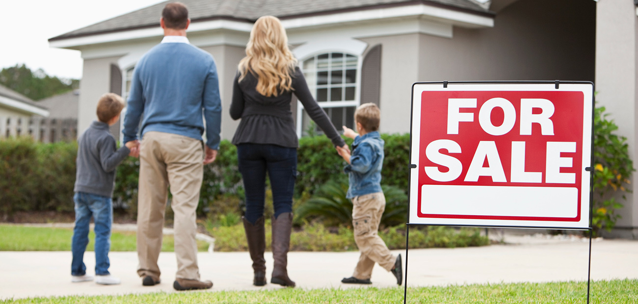 family in front of home for sale