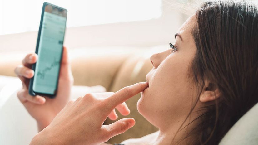 Young girl on cell phone examining her credit score
