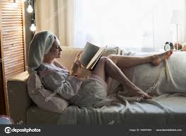 lady reading book on couch