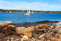 A beachside image of two sailboats in Canaan NH