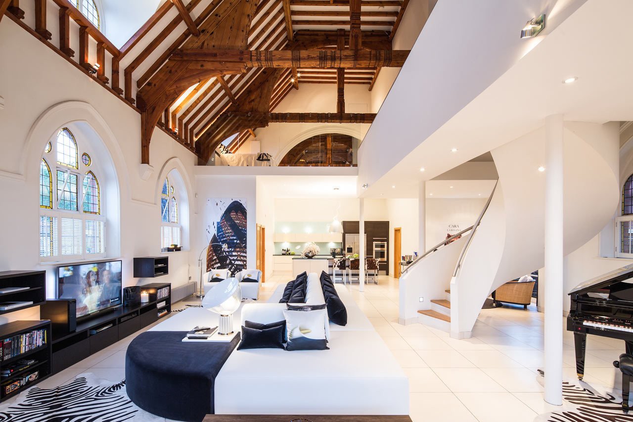 In London, a late-1800s brick church was converted into a single-family home. The church's roof structure was left exposed, while and a mezzanine was inserted into the building to take advantage of the high ceilings.