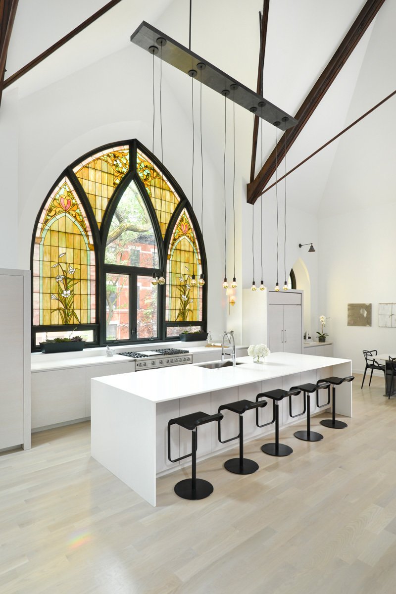 This church conversion in Chicago was transformed into a single-family home. Arched stained-glass windows were maintained, and some panels were swapped out for clear glass.