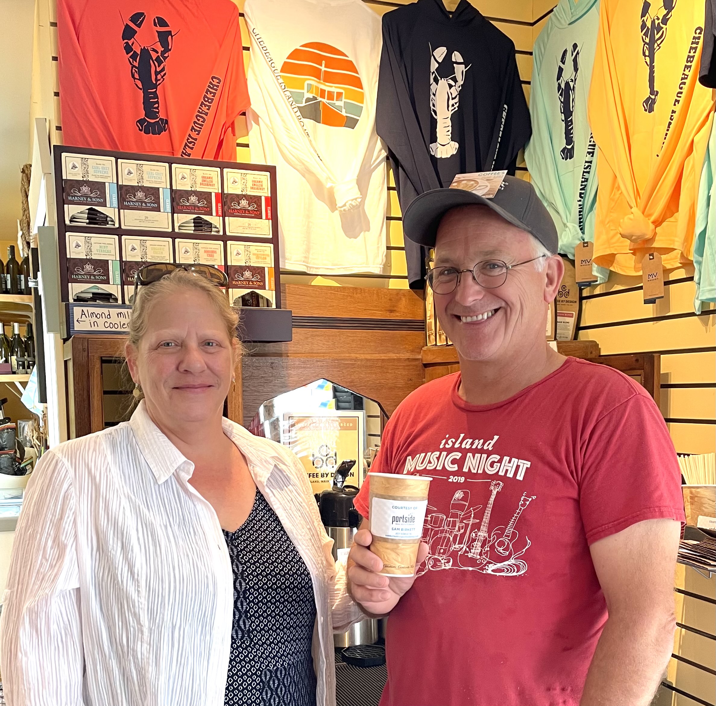 Two people standing enjoying cofee
