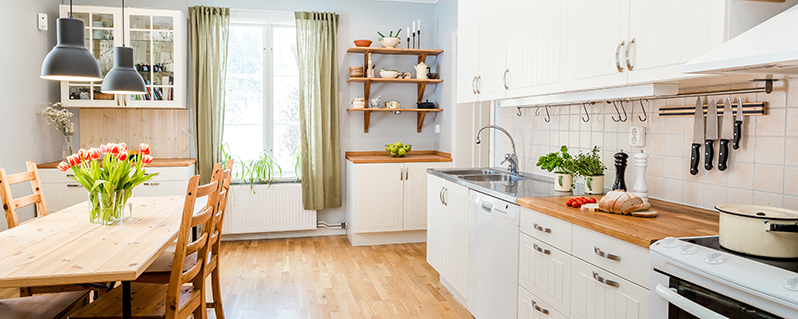 Bright kitchen with wooden kitchen table.