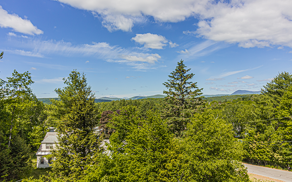 Rural road with home in foreground