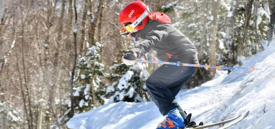 Mountain in the green mountain range in Vermont with ski trails visible during wintertime