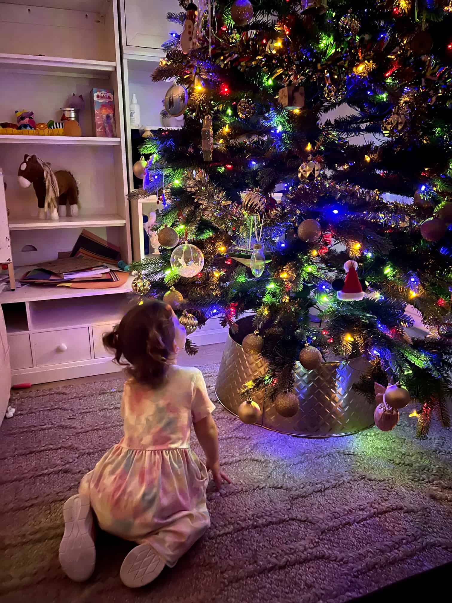 Child Looking Up at Christmas Tree