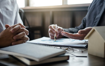 two men in suits shaking hands