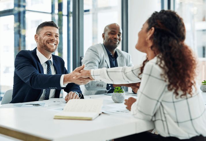two men in suits shaking hands