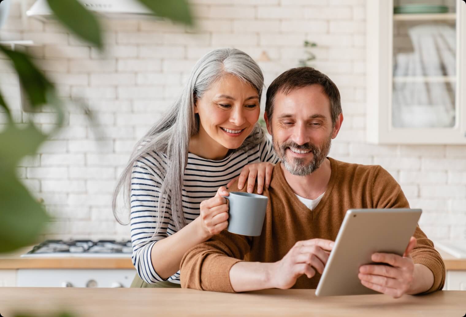 A couple is using a laptop