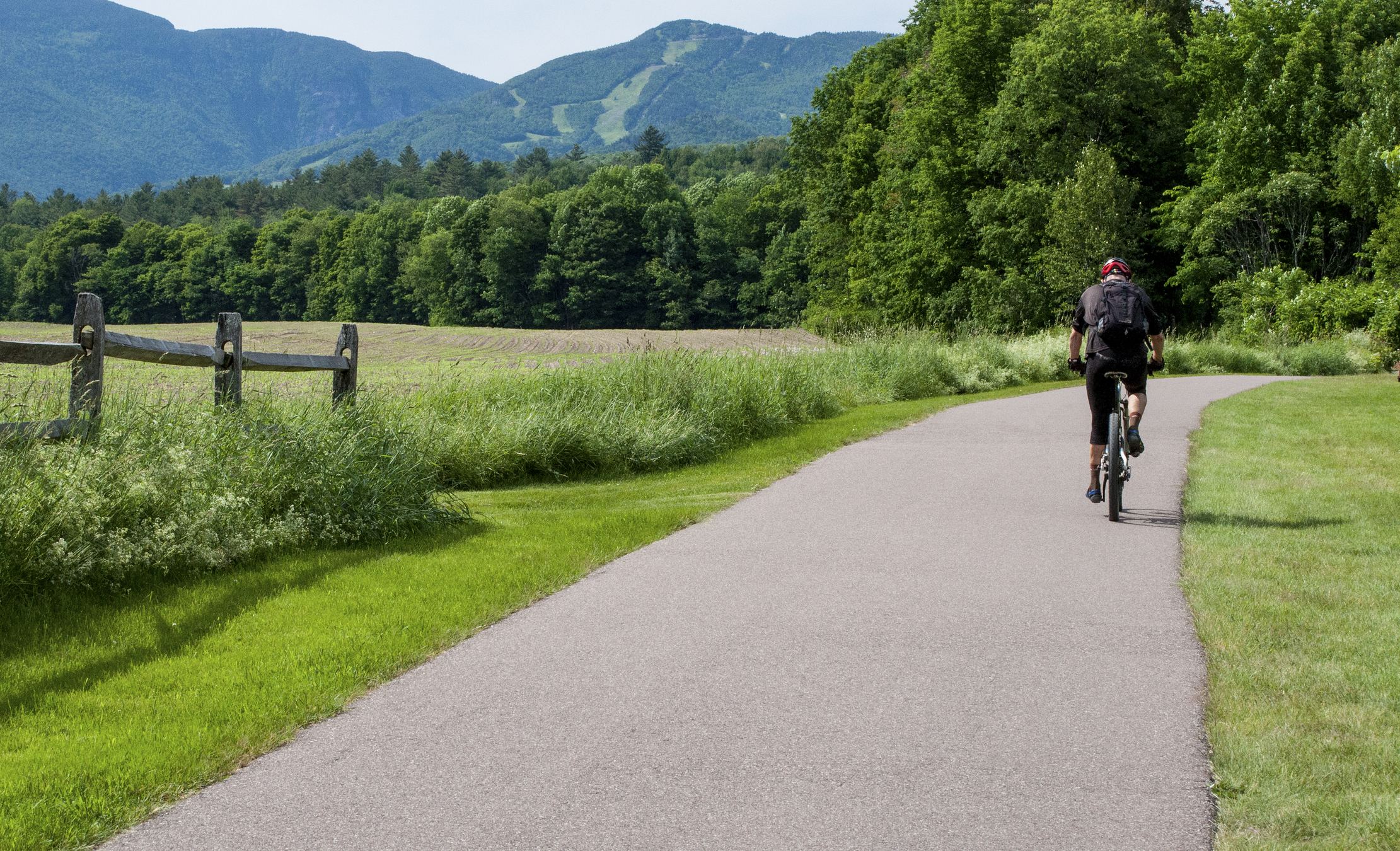 A bicycle rider pedals over the Recreation Path in