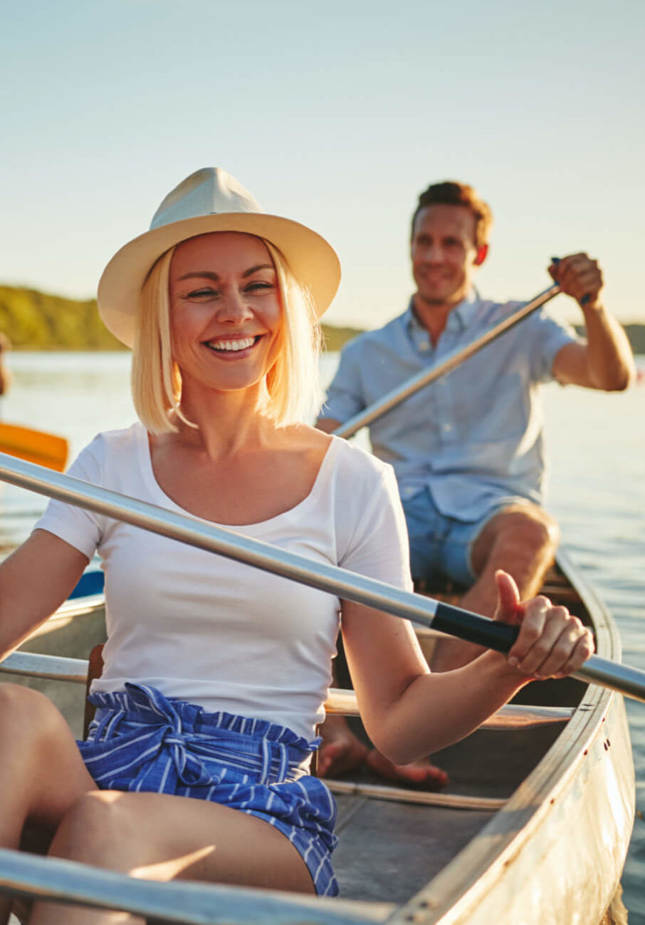 the happy couple are swimming by boat on the lake