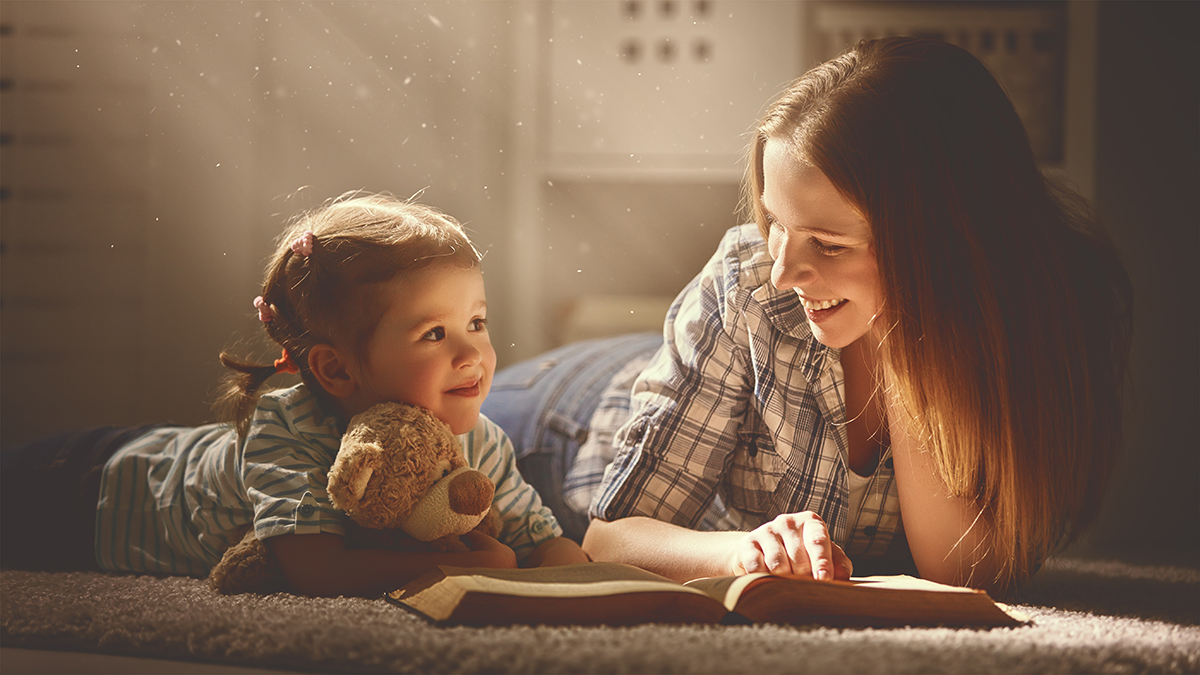 Child reading with a caregiver