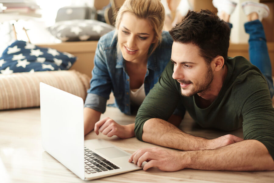 Couple Smiling and Looking at Computer