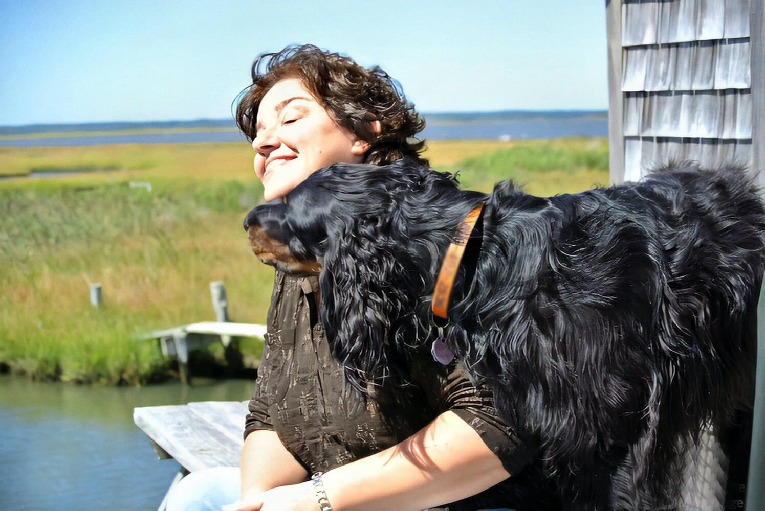 Benée Scola on Sandy Island off of Harvey Cedars getting a friendly greeting from the resident pup.