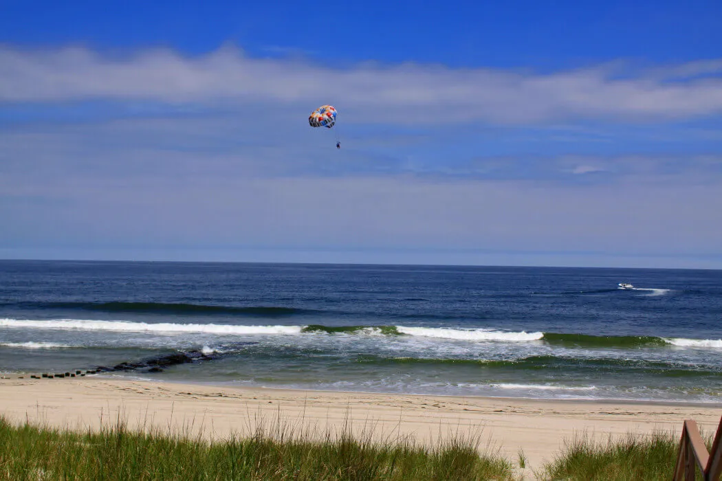 Paraglider over an ocean view and beach in Loveladies, New Jersey