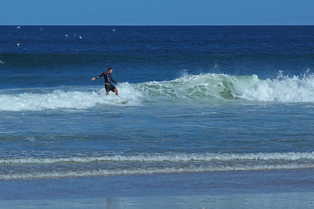 Surfer catching a wave in the ocean near Harvey Cedars, New Jersey
