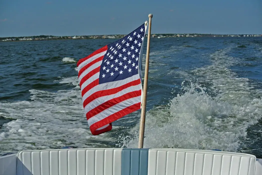 An American flag on the back of a boat along the coast of Long Beach Island