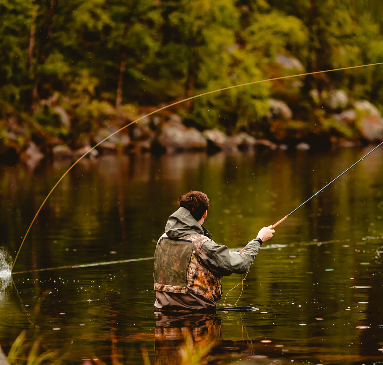 man is fishing in the river