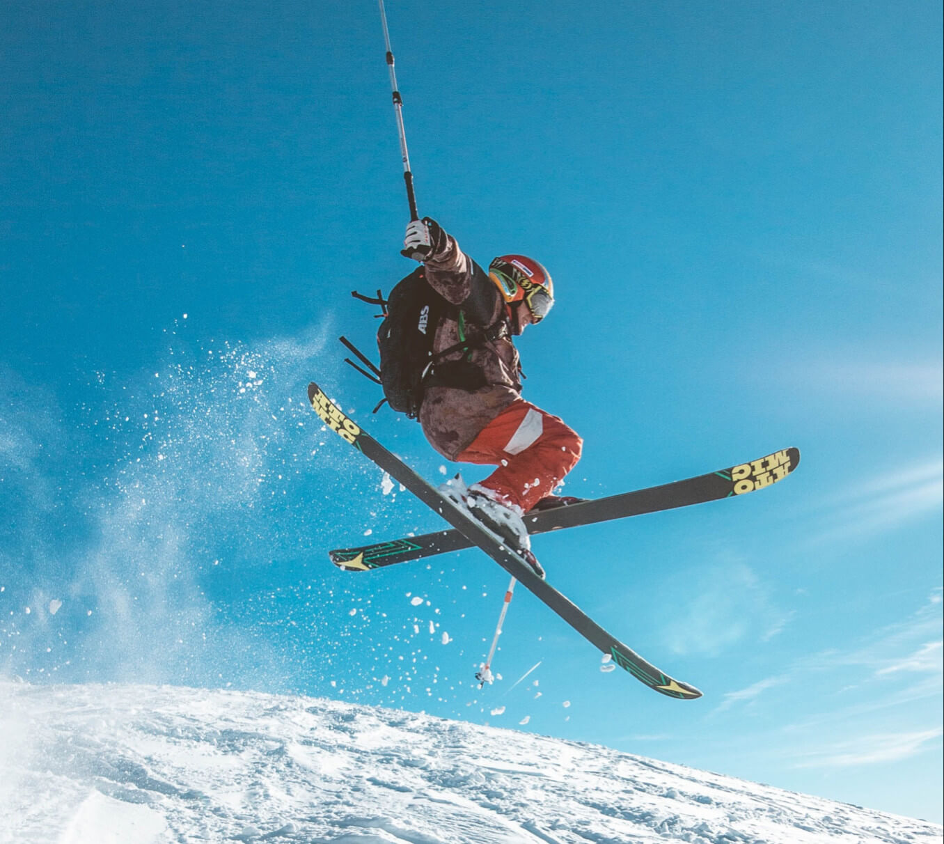 someone is jumping on the downhill skiing