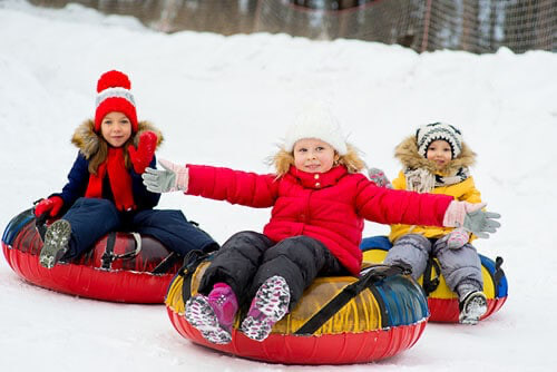 children riding from the hill