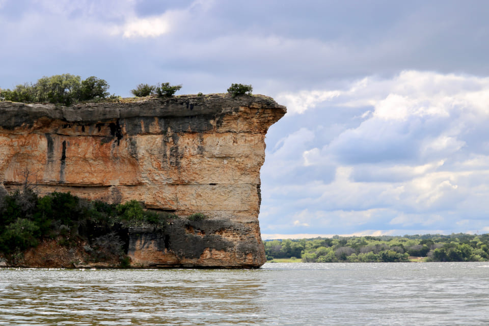 boats at dock on a lake with blue sky