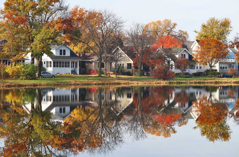 homes on water in fall with nice reflection on water