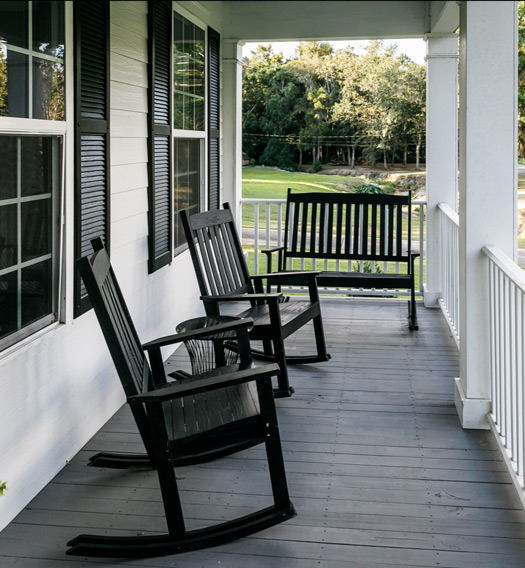 Front porch with rocking chairs and bench
