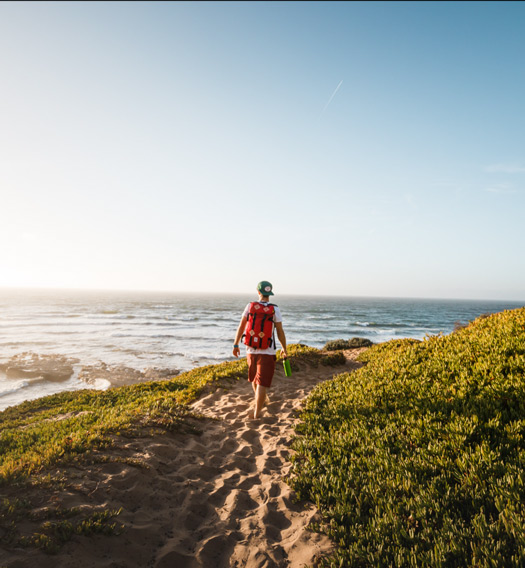 Gentleman walking on a trail near the oceean