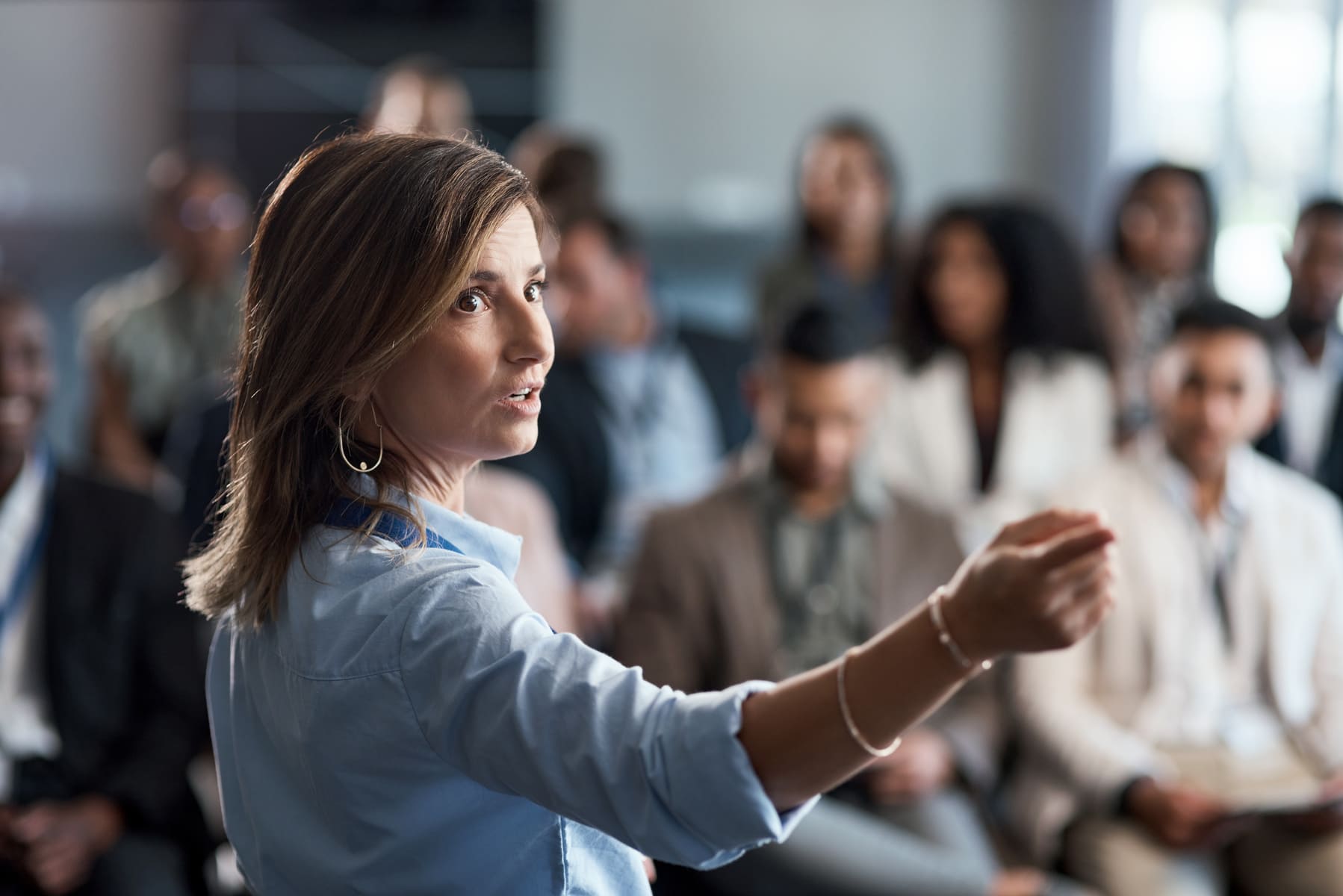 Woman giving a seminar to a group of employees